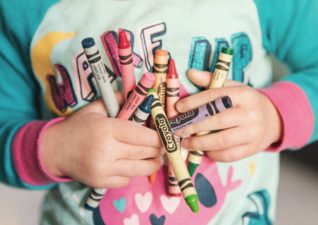 interior tips children - a picture of a toddler holding an armful of Crayola wax crayons